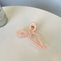 Detail view of the elegant pink bow hair claw clip with transparent acrylic and metal spring - Approx. 9.5cm / Pink