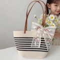 Detail of woven straw tote with floral lace bow and brown leather handle rivets - Beige Hollow with Streamer and Beige Shoulder Strap