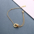 Gold titanium steel bracelet featuring interlocking Roman numeral and pavé crystal rings - Gold