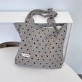 Detailed view of canvas tote bag featuring grey plaid, red polka dots, and bow embroidery - Bowknot Grey
