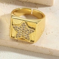 Detailed close-up of 14K gold plated star ring with zircon on stone surface - Star Style