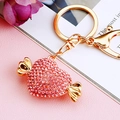 Golden keychain with red rhinestone candy pendant and gold bow accents on pink leather - Single Pack / Candy Pink
