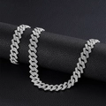 Macro shot of silver-colored iced-out Cuban link chain and bracelet on leather roll - 8inch Bracelet + 24inch Necklace / Silver