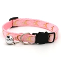 Close-up of pink pet collar with gold moon star patterns and black cat safety buckle - Pink