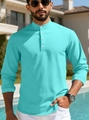Detail of light blue waffle knit polo shirt with four-button placket and stand collar - Teal