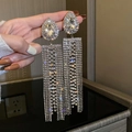 Macro shot of silver tassel earrings with sparkling rhinestones and drop-shaped crystal - Silver Rhinestone Tassel Style 2 (Silver Earring Post)