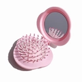 Portable pink folding hairbrush with integrated mirror and soft air cushion bristles - Pink Cloud Folding Hairbrush