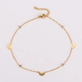Macro shot of gold anklet with crescent moon charms and clear crystal pendants - Moon Style / Gold