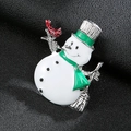 Close-up of a festive enamel snowman brooch with a red scarf on black leather background - Silver Christmas Snowman