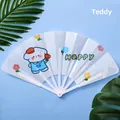 Portable folding fan featuring a cute cartoon dog on a white semi-transparent plastic surface - Cute Dog