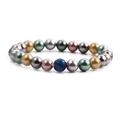 Pulsera de perlas metálicas de 8 mm con una cuenta central de piedra azul texturizada - Huevo de Volcán Azul