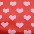 Christmas wrapping paper with pink heart patterns on a vibrant red background texture - Red with White Hearts