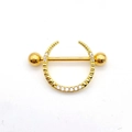 Detailed close-up of golden stainless steel nipple ring with sparkling zircon shield - Gold - Single Row Zircon Shield