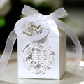 Macro shot of white laser-cut wedding favor box with gold tag and organza ribbon - White With Gift Tag