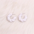 Exaggerated white twisted C-shaped acrylic hoop earrings on a soft texture background - White Twisted
