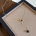 Close-up of golden snake chain with tiger eye shell round pendant in Maillard vintage style - 43# Gold Coffee Necklace