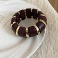 Detailed macro view of acrylic stretch bracelet with burgundy and gold rectangular blocks - Round Style / Gold-Red