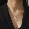 Elegant silver stainless steel necklace with Celtic knot pendant worn on black suit blazer - Silver + O-chain