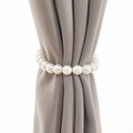 Elegant curtain tieback featuring large cream white faux pearls on grey fabric drapery - Pearl Bead Tieback