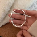 Detail of silver irregular stream-line bracelet with round white pearls on wrist - Silver Retro Pearl Streamline (MY31421)