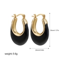Macro shot of U-shaped enamel hoop earrings with gold and black color-blocking design - Gold + Black