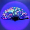 Black bamboo folding fan featuring a fluorescent Tree of Life pattern in neon colors - Tree of Life UV Glow A38