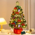 55cm mini Christmas tree with red bows, pine cones, and bells on a warm tabletop - 55CM Standard Kit
