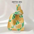 Detailed close-up of yellow floral knitted handbag with green leaf texture and patterns - Yellow Tulip