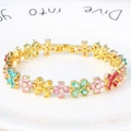 Colorful four-leaf flower bracelet with zircon stones in gold plated finish on white plate - Colorful