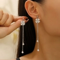 Detail of clover earrings with long silver tassels and white pearls on a model - Silver Clover Pearl Tassel Style (2399)