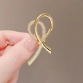 Handheld view of a gold knot brooch with pave-set sparkling zircons for coat accents - 240# Double Ring