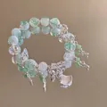 Detail of beaded bracelet with green crystal beads, silver butterfly and ginkgo charms - Silver-Green