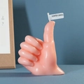 Pink thumb up shaped scented candle with a white SCENTED CANDLE label on top - Pink