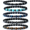 Detailed view of five elastic beaded bracelets featuring matte black and natural stones - Frosted Set