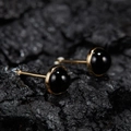 Macro shot of minimalist gold S925 silver stud earrings with round black jasper stones - Natural Black Agate Round Gold 5mm