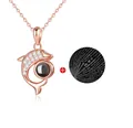 Detail of rose gold dolphin pendant with micro-engraved projection stone showing I love you - Dolphin Rose Gold