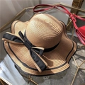 Women's summer straw sun hat with wide wavy brim and large black bow accent - One Size / Khaki