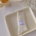 Classic white ribbed crew socks with brand paper label in minimalist aesthetic setup - Milk White