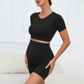 Black seamless maternity workout set featuring high-waist yoga shorts and short sleeve top - S / Black