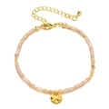 Detail of natural stone beaded bracelet with golden hammered coin charm and lobster clasp - Pink