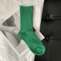 Vibrant green ribbed knit high-elastic crew sock displayed on a fashion magazine background - Green