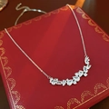 Detail shot of silver necklace with clear zircon stones on a red patterned box - Silver