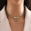 Handmade necklace with green jade beads, pearls, and a vintage gold pendant on a model - Green Aventurine Necklace