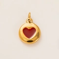 Detailed macro view of a 18k gold plated round pendant with a red enamel heart center - Gold Round Red Heart Pendant