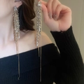 Close-up of silver tassel earrings with wheat-ear fringes worn by a model - Two-Tone Metal Leaf Layered Extra Long Tassel Earring / 37# Silver Needle Studs - Silver & Gold