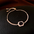 Golden bolo bracelet with oval purple gemstone and pavé zircon surround in luxury setting - Gold Purple Stone Bolo Bracelet
