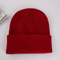Detailed top view of a dark red ribbed knit beanie on a clean light gray background - Adult 56-60cm / Burgundy
