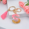 Pink tassel keychain with resin letter S pendant featuring gold leaf and pink glitter accents - S