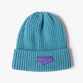 Sky blue knit beanie with ribbed texture and purple rubber letter patch for unisex wear - Light Blue