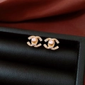 Detailed view of 14k gold-plated pearl earrings with CC logo on black leather box - Classic Letter Logo Style (Silver Needle Gold Letter Gold Plated)